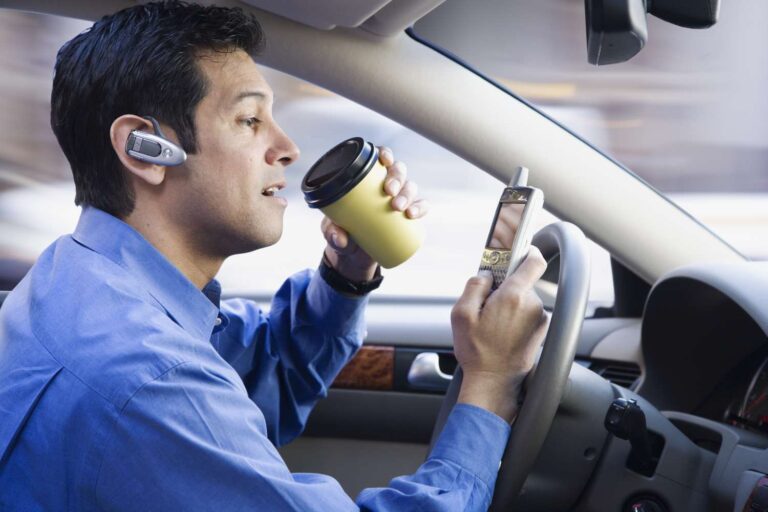 Image of a driver distracted while driving for Distracted Driving Awareness Month